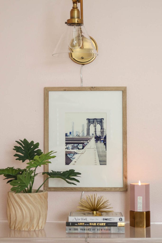 blush bedroom with art and gold lamp