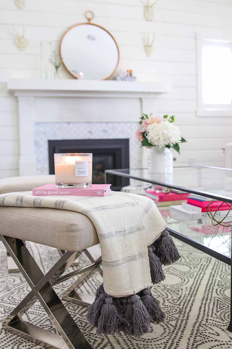 simple summer decorating ideas: throw with tassels styled with candle and book