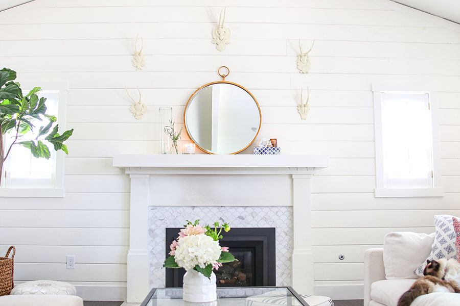 White shiplap wall with mantel and mirror