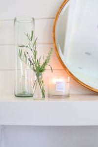 candle on mantel with lavender, rosemary and olive branches