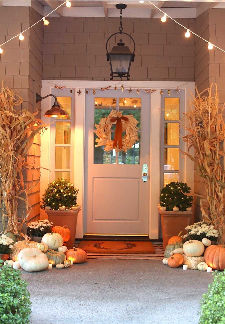 fall porch decorated with pumpkins and cornstalks