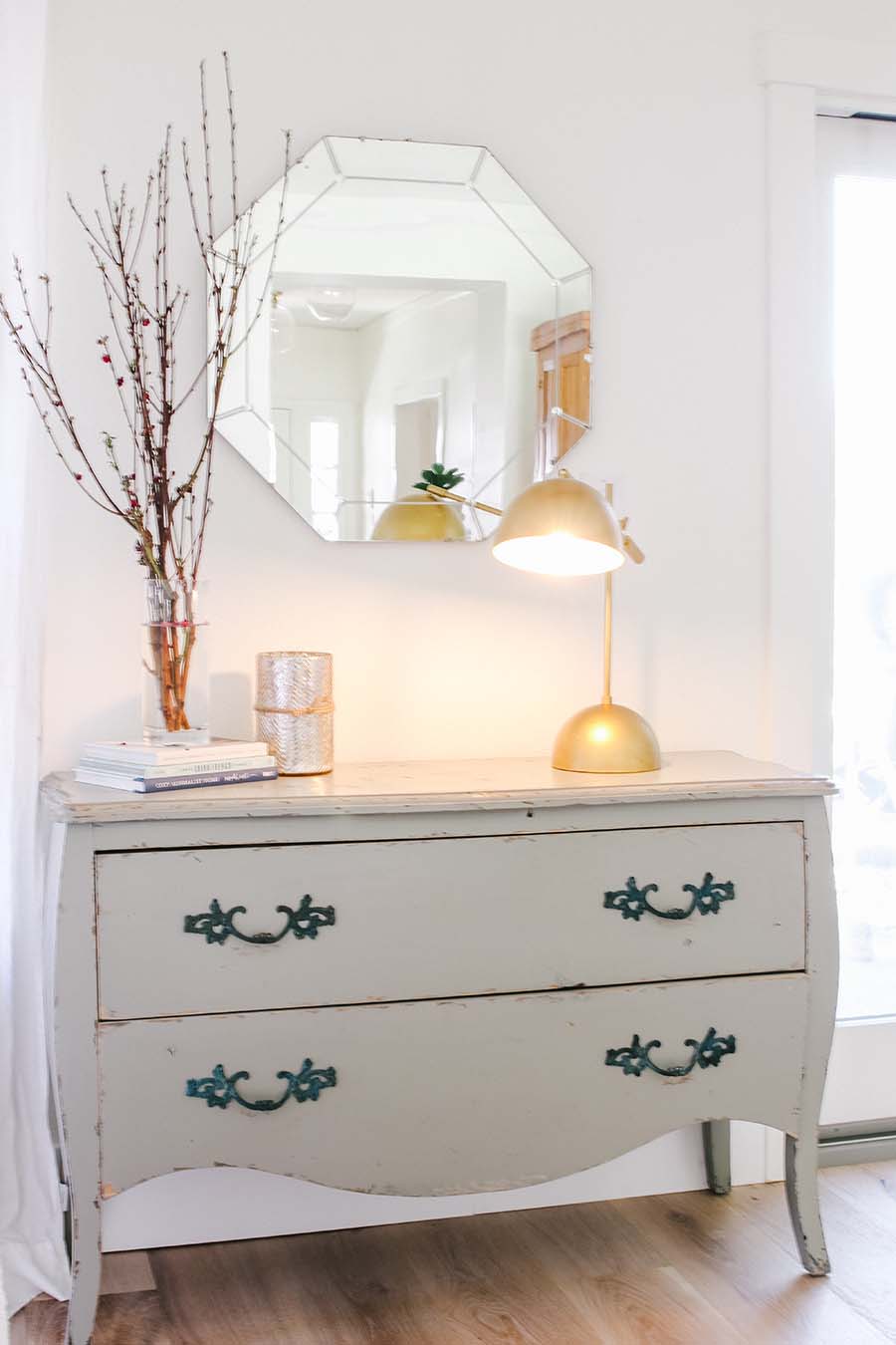 chest of drawers with mirror and lamp