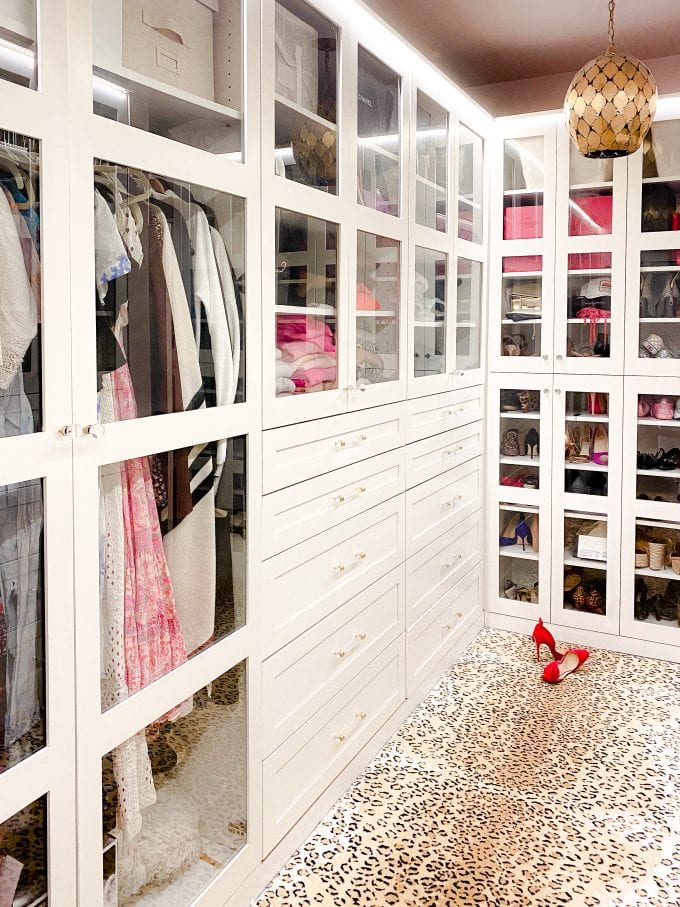 walk in closet with white cabinets