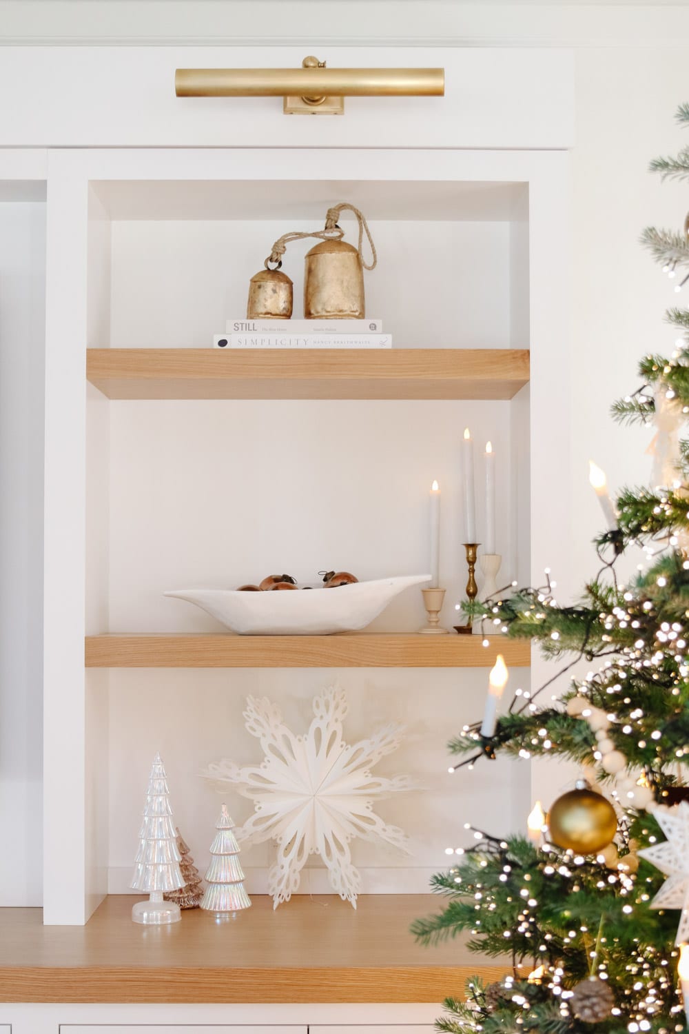 cozy holiday shelf with lights and ceramic houses.